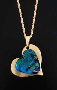 Light blue heart on gold medallion